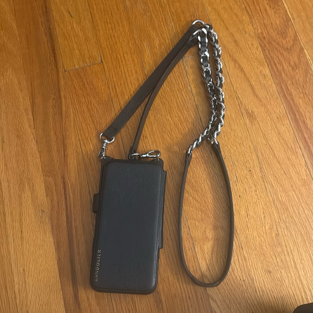 Gently used Bandolier case with strap that has silver hardware detail